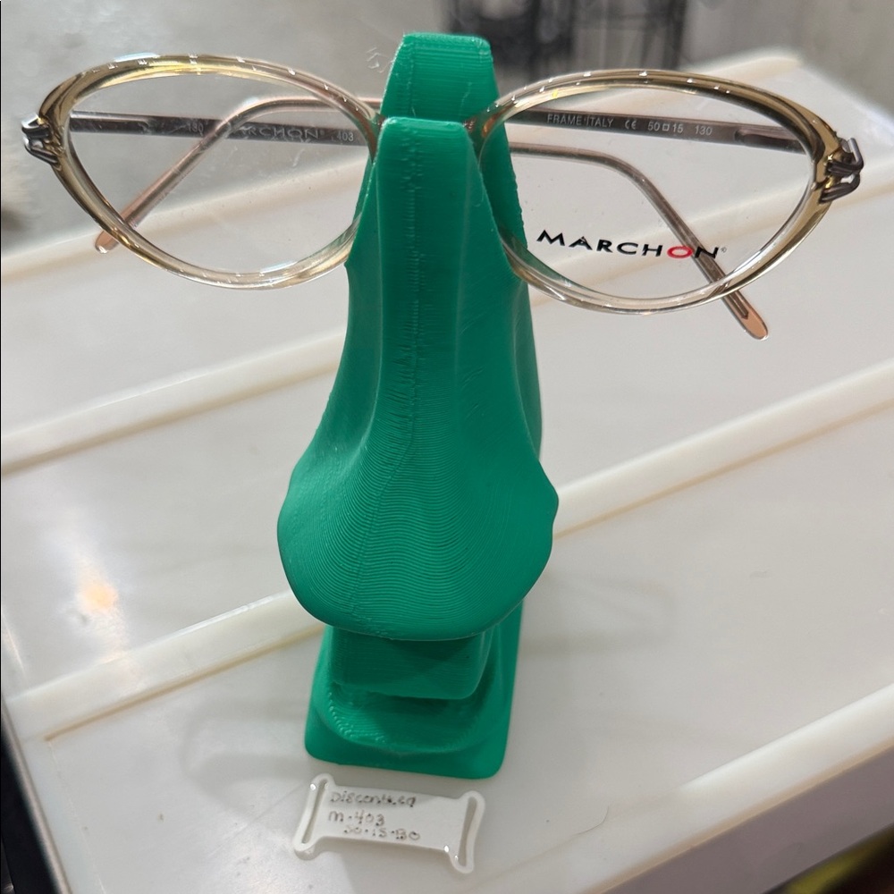 Marchon eyeglass frames in a translucent peach color with metal‎ temples.